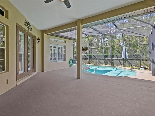 pool with glass enclosure, a patio area, and french doors