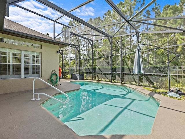 outdoor pool featuring a lanai and a patio area