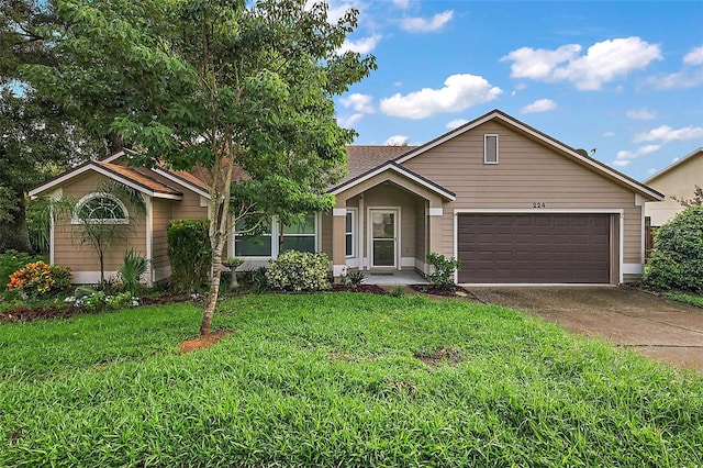 ranch-style house with a garage and a front lawn