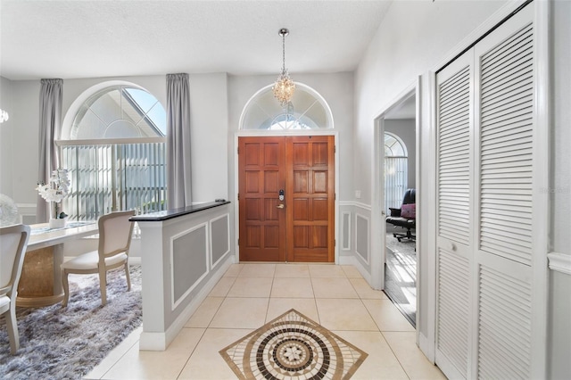 entryway featuring a textured ceiling and light tile patterned flooring