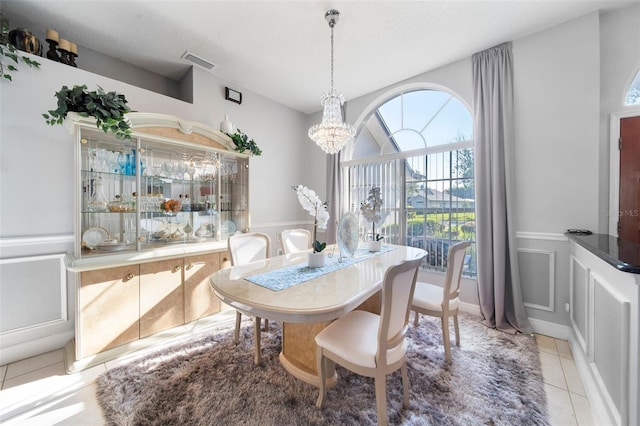 tiled dining space with a notable chandelier