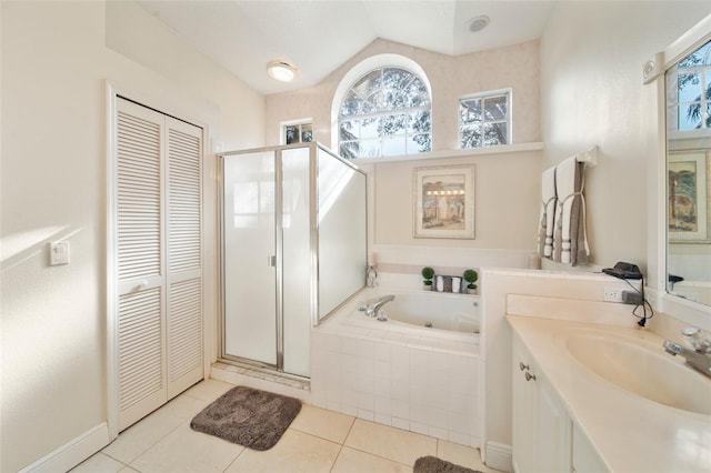 bathroom with plus walk in shower, tile patterned flooring, and vanity