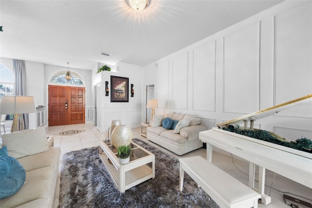 living room with light tile patterned flooring and a chandelier