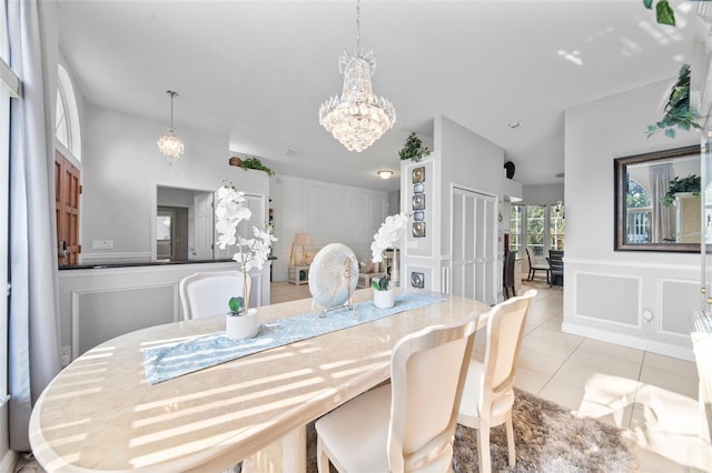 dining space with a notable chandelier and light tile patterned floors