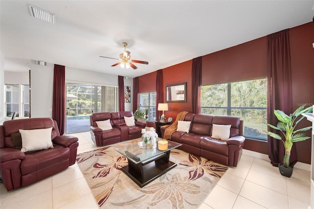 living room with ceiling fan and light tile patterned flooring