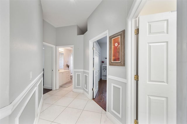 hall featuring light tile patterned floors