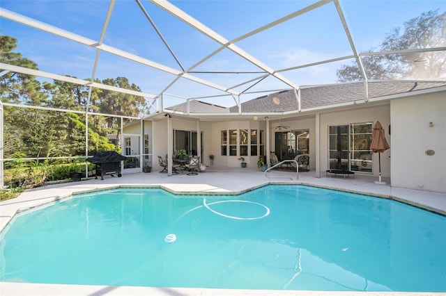 view of pool featuring ceiling fan, a patio, a grill, and a lanai