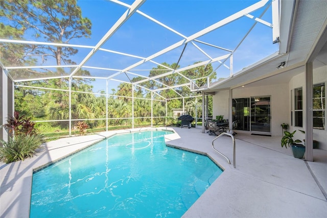 view of swimming pool with a lanai and a patio area