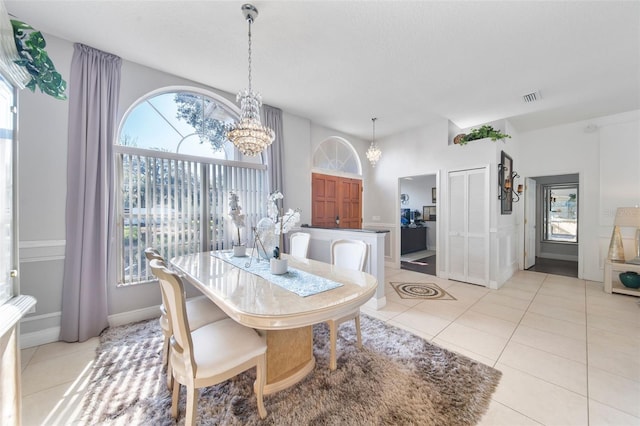 tiled dining space featuring a chandelier