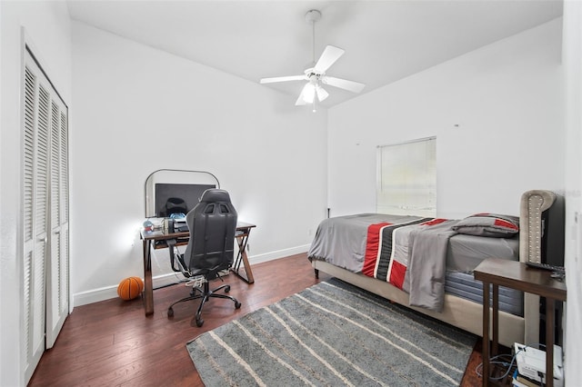 bedroom featuring ceiling fan, a closet, and dark wood-type flooring