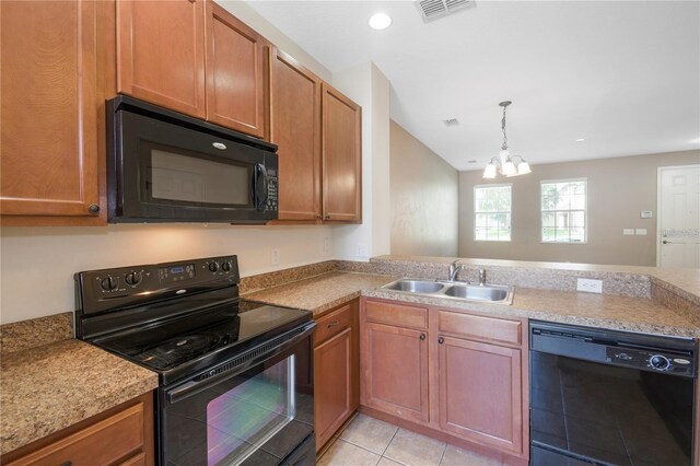 kitchen with light tile patterned flooring, an inviting chandelier, sink, and black appliances