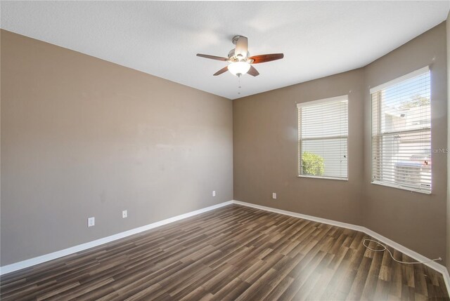 spare room featuring ceiling fan and dark hardwood / wood-style flooring