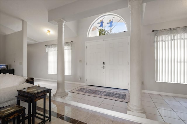 2101 Appy Ln, Apopka, FL 32712 - entryway with ornate columns, tile patterned floors, healthy amount of natural light, and lofted ceiling