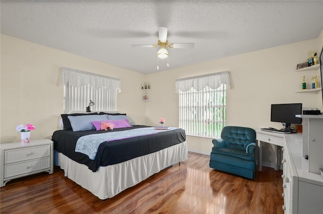 2101 Appy Ln, Apopka, FL 32712 - bedroom featuring wood finished floors, ceiling fan, an office area, and a textured ceiling