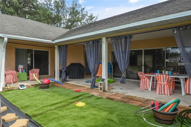 2101 Appy Ln, Apopka, FL 32712 - rear view of house featuring a patio, a shingled roof, and a yard