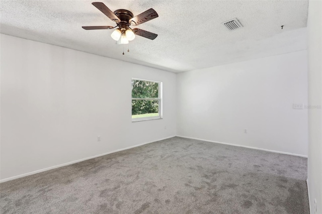 empty room with carpet flooring, ceiling fan, and a textured ceiling