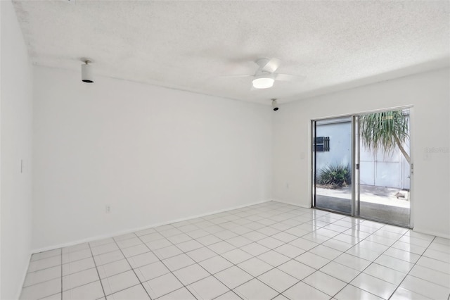 tiled empty room with a textured ceiling and ceiling fan