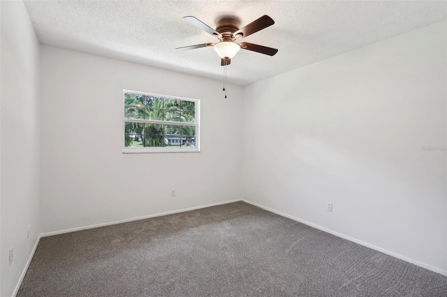 carpeted spare room featuring ceiling fan and a textured ceiling