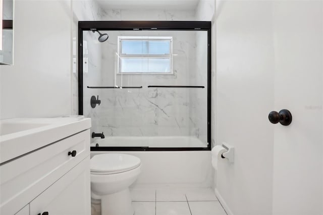 full bathroom with tile patterned flooring, vanity, toilet, and tiled shower / bath