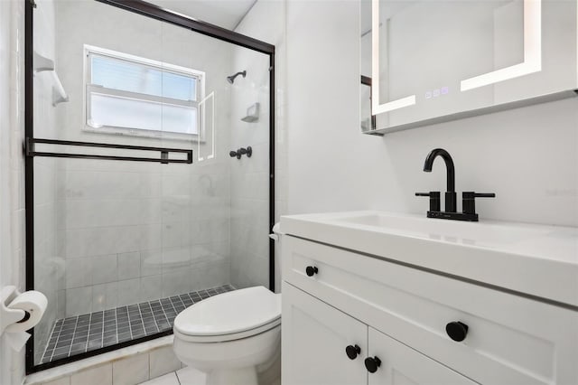 bathroom with vanity, toilet, walk in shower, and tile patterned flooring