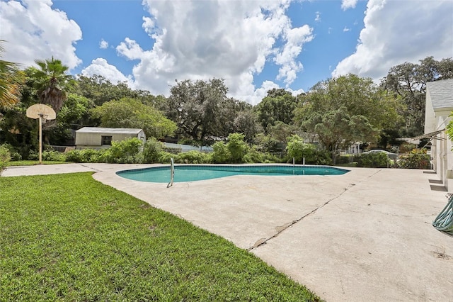 view of swimming pool featuring a yard and a patio