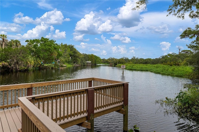 dock area with a deck with water view and a forest view