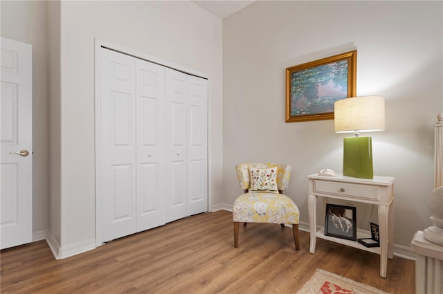 living area featuring wood finished floors and baseboards