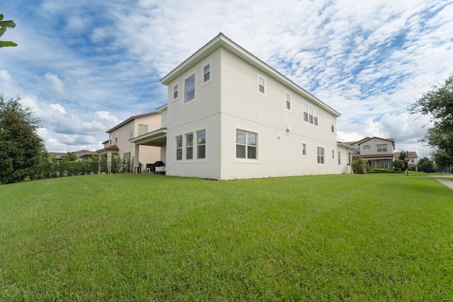 back of house with a yard