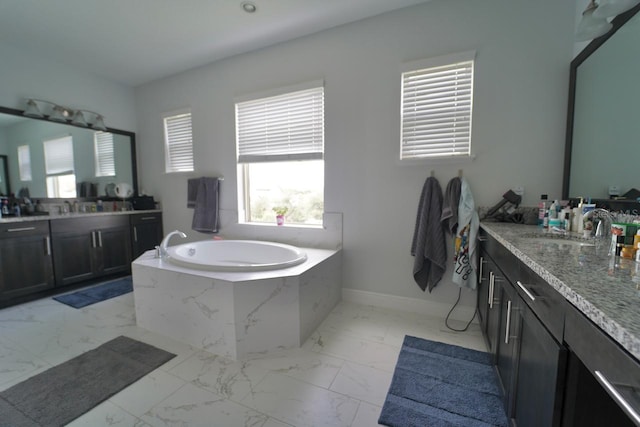 bathroom with vanity and a relaxing tiled tub