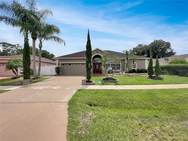 ranch-style home with a garage and a front lawn