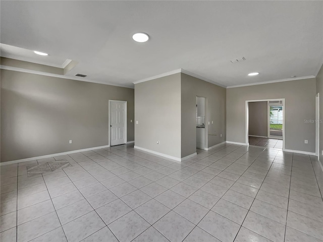 spare room with light tile patterned floors, visible vents, crown molding, and baseboards