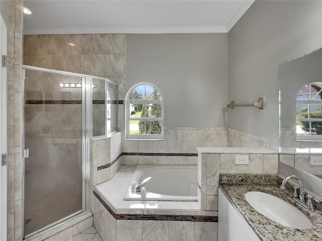 full bathroom featuring crown molding, vanity, a garden tub, a stall shower, and tile walls