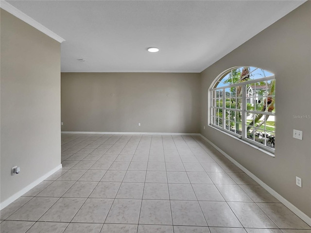 spare room with light tile patterned flooring and baseboards