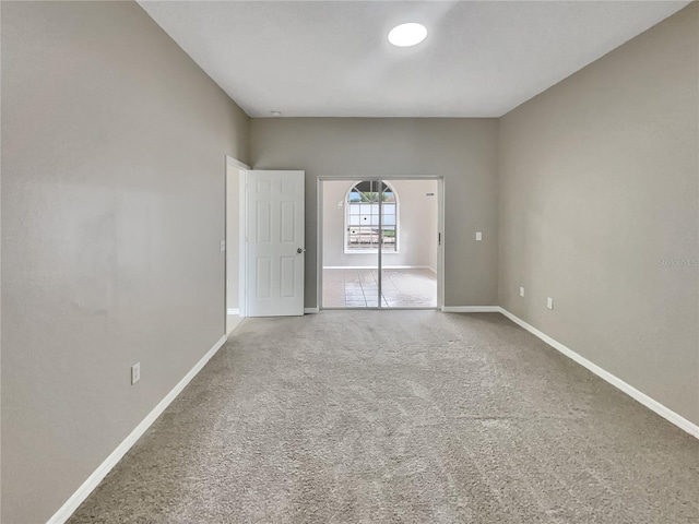 carpeted spare room with baseboards