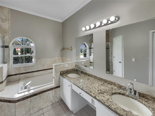 bathroom featuring crown molding, vanity, tiled tub, and tile patterned floors