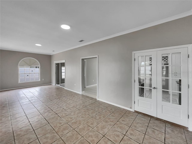 empty room featuring ornamental molding, light tile patterned flooring, and french doors