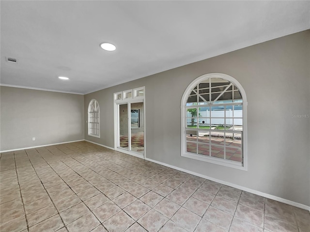 unfurnished room featuring baseboards and visible vents