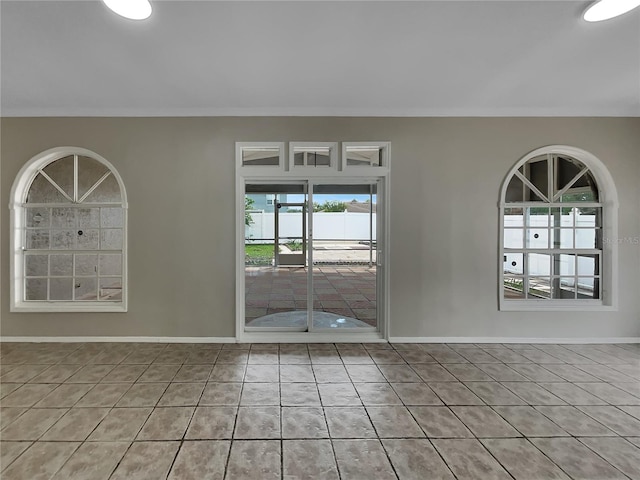 tiled empty room with ornamental molding