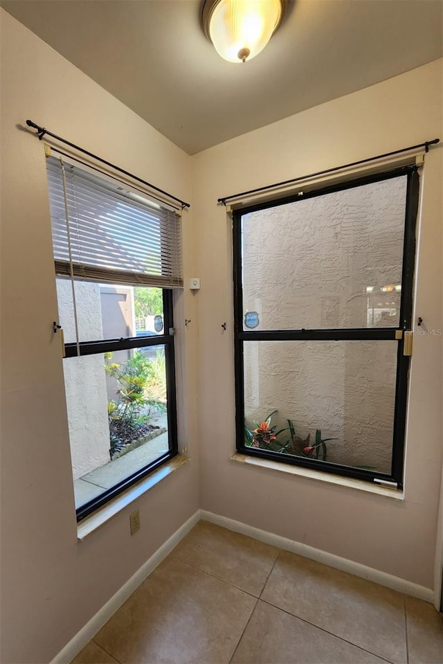 spare room featuring light tile patterned flooring