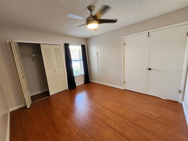 unfurnished bedroom featuring hardwood / wood-style floors, ceiling fan, and a textured ceiling