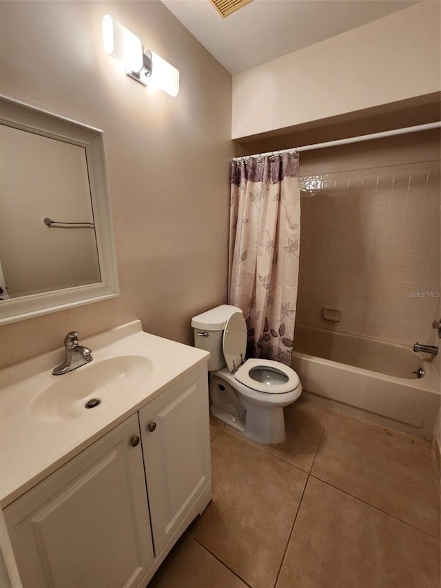 full bathroom featuring tile patterned floors, shower / bath combination with curtain, toilet, and vanity