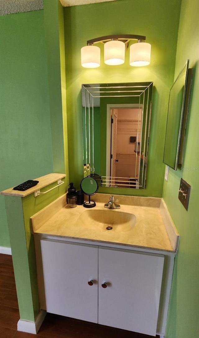 bathroom featuring vanity and hardwood / wood-style flooring