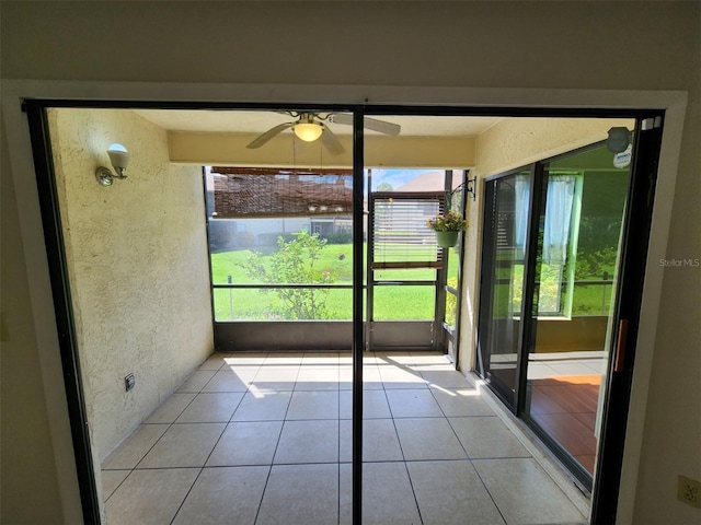 unfurnished sunroom featuring ceiling fan