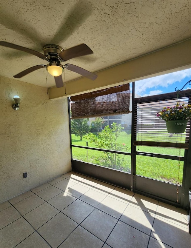 unfurnished sunroom featuring plenty of natural light and ceiling fan