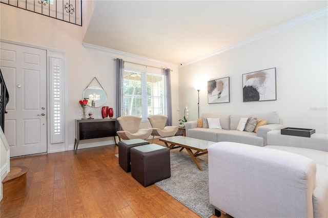 living room featuring wood-type flooring and ornamental molding