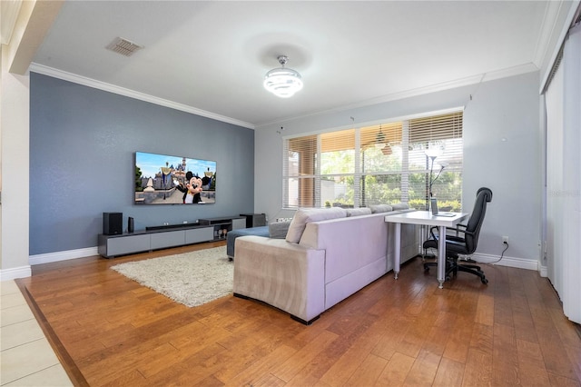 living room with wood-type flooring and crown molding