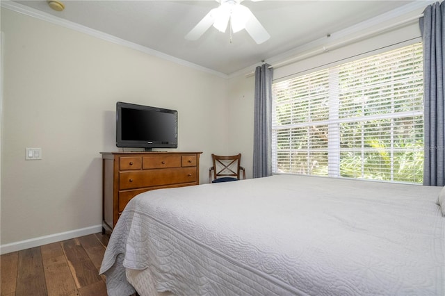 bedroom featuring ceiling fan, crown molding, and dark wood-type flooring