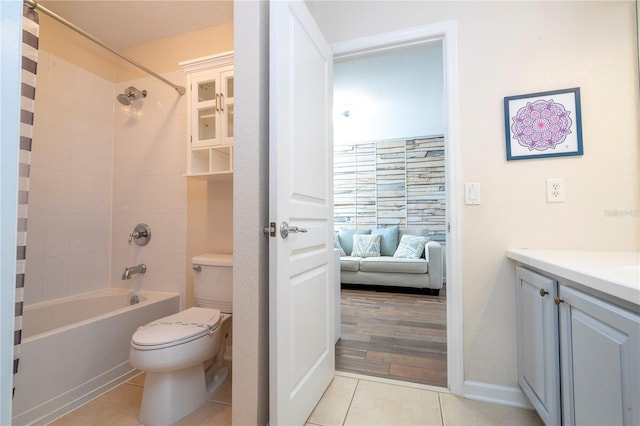 full bathroom featuring tiled shower / bath, hardwood / wood-style flooring, vanity, and toilet