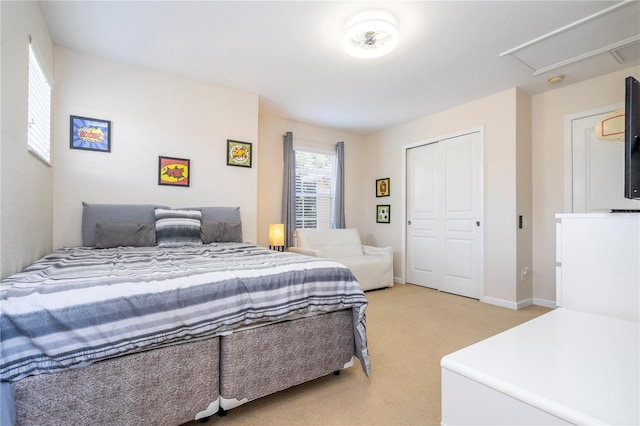 bedroom featuring light colored carpet and a closet