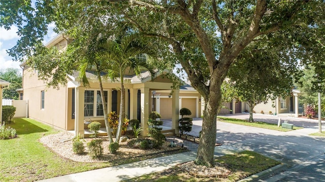 view of front of property featuring a front yard and a garage